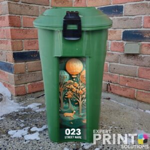 Paper art with hot air balloon flying over trees Green Bin Sticker