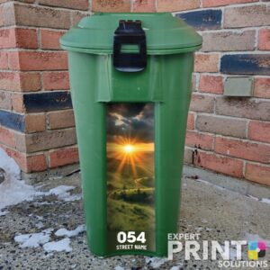 Sun rises over a hillside with grassy fields Green Bin Sticker
