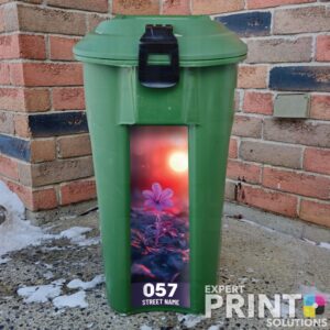 Vibrant purple flower blooming at sunset Green Bin Sticker