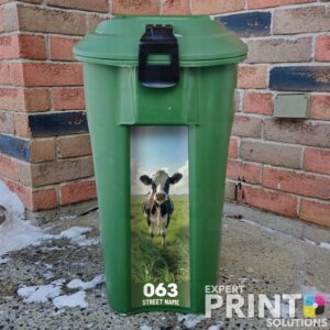 Cow standing in green field Green Bin Sticker